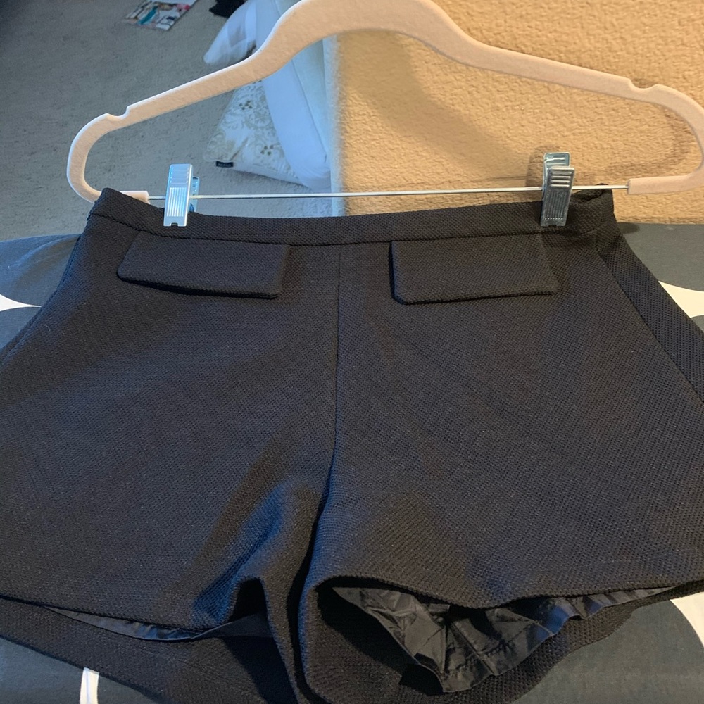 Set of dressy and formal black blouse with shorts.